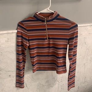 Lightly worn, comfy long sleeve striped top. Fashionable Front zipper.